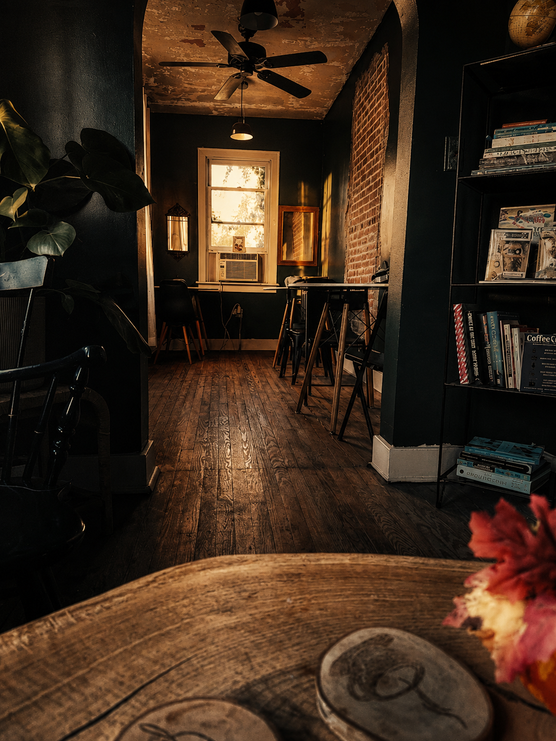 A sunlit quiet room with books and wooden floors